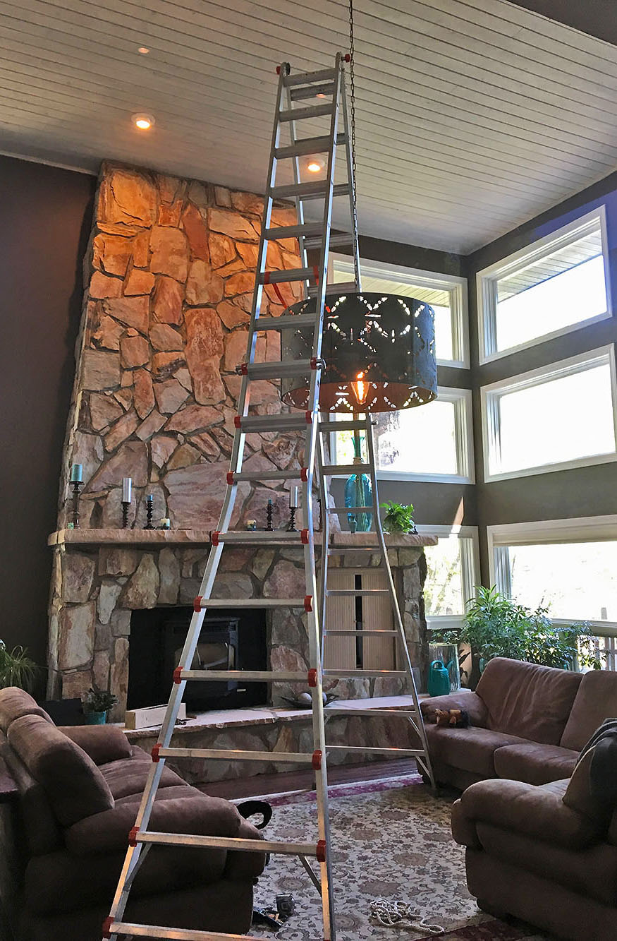 Mounting a ceiling light fixture in a lving room in a custom home in Flagstaff